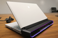 A computer sitting on a wooden table Description automatically generated